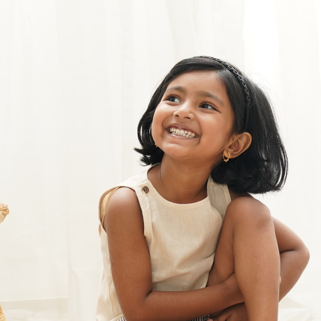 A smiling girl in cotton clothing
