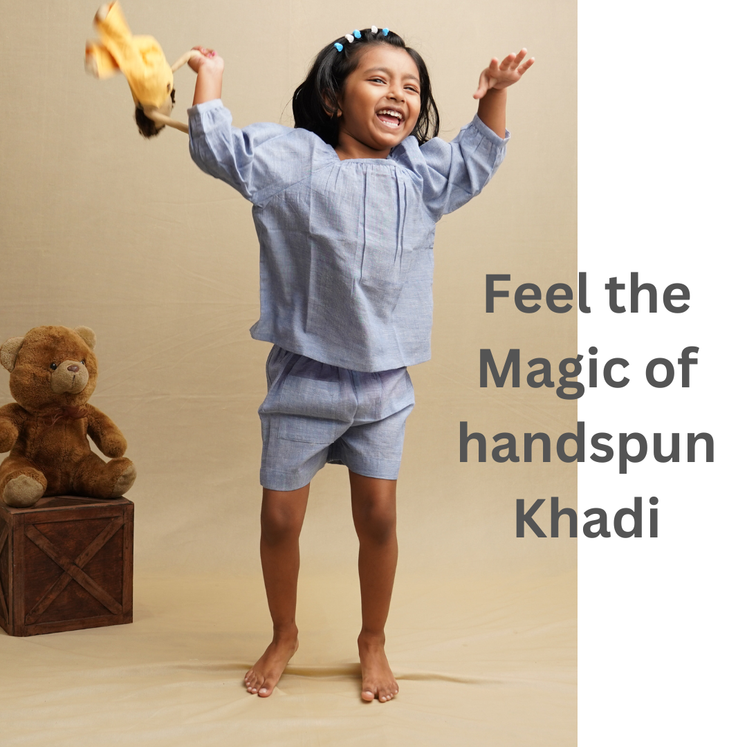 Playful girl wearing cotton top and shorts set against a beige background