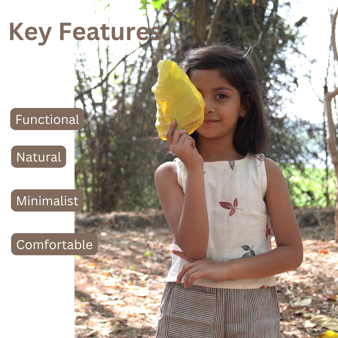 Child wearing Khadi clothes holding a yellow leaf outdoors with text 'Key Features' on the left.