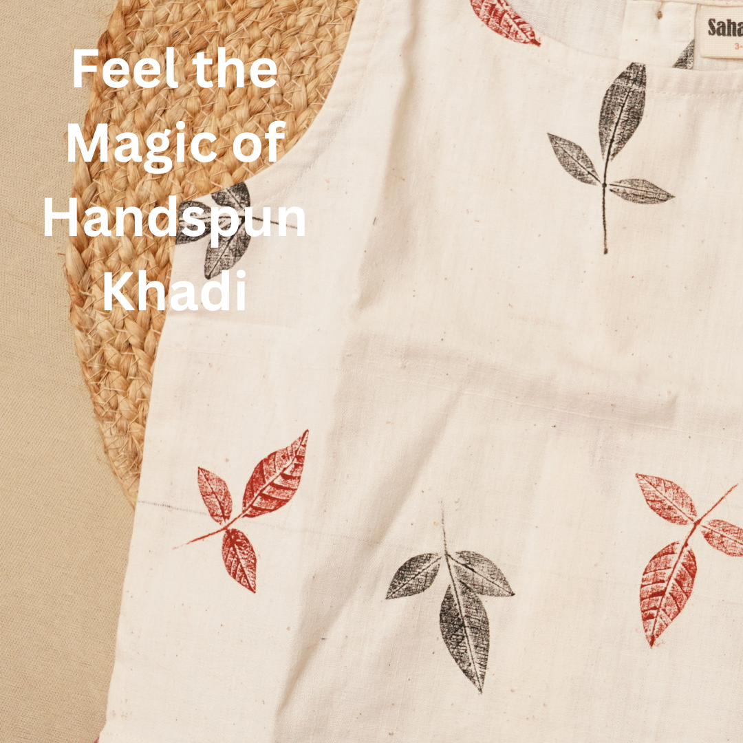 Text 'Feel the Magic of Handspun Khadi' on a khadi fabric with leaf patterns