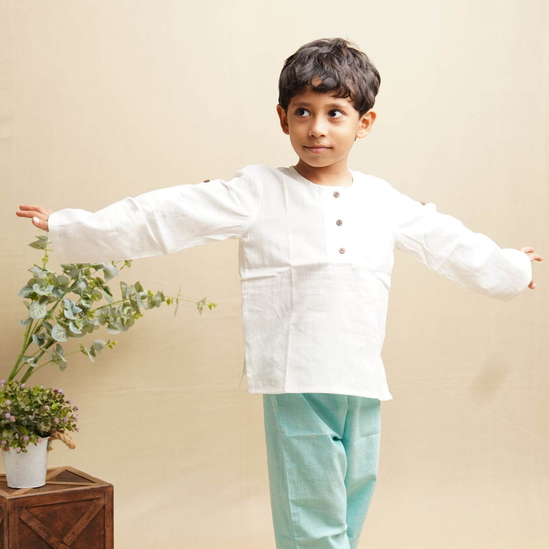 Boy stretching his hand wearing full sleeve cotton shirt in white color