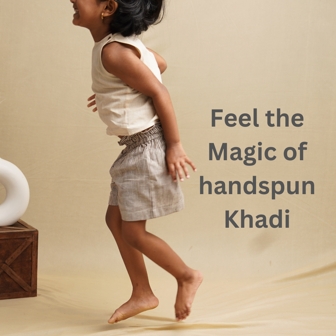 Girl wearing khadi clothing set and jumping against a beige background
