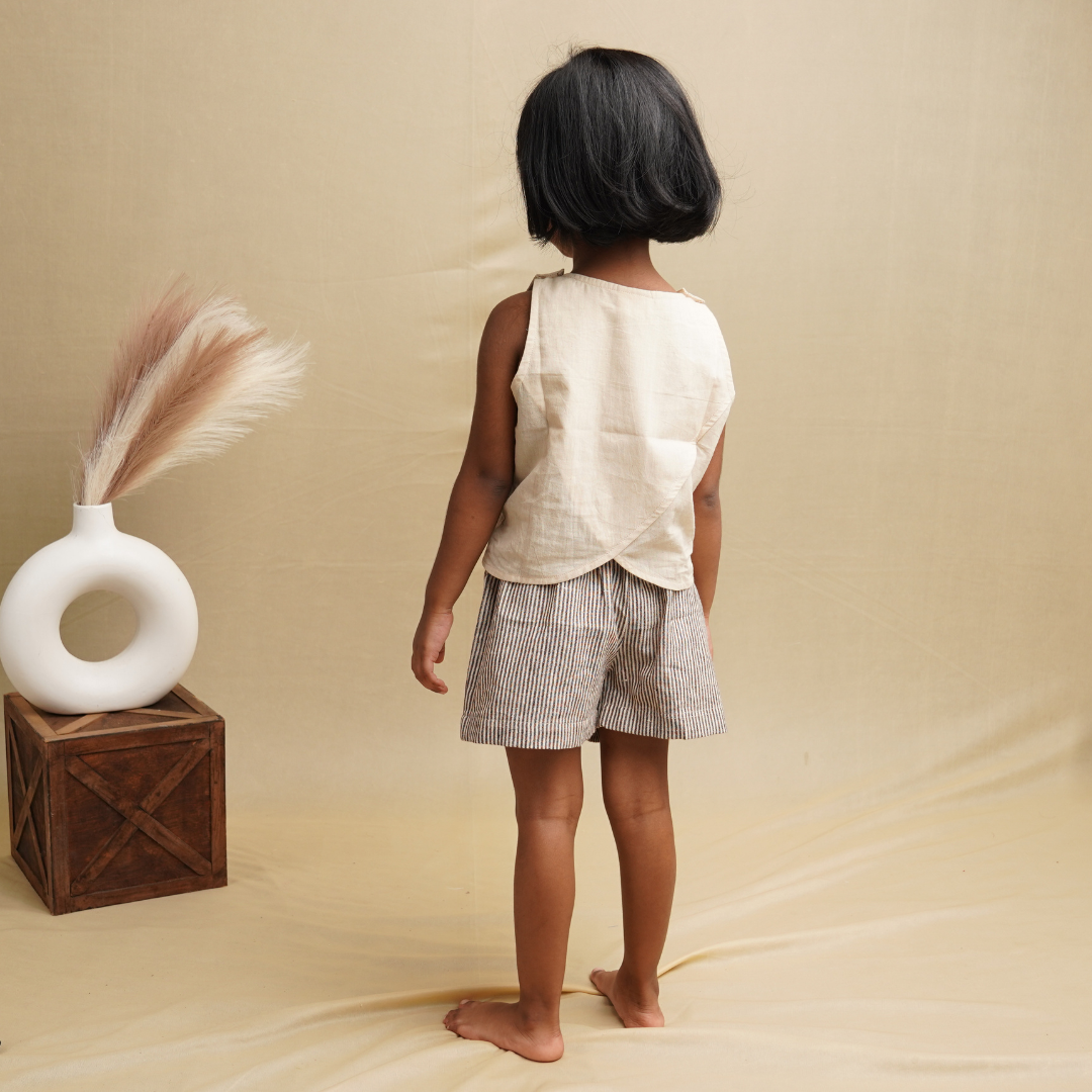Elegant design of khadi crop on a little girl against beige background