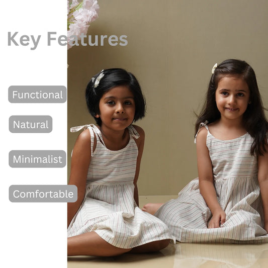 Girl wearing Stripe Song white cotton dress – comfortable everyday outfit for kids