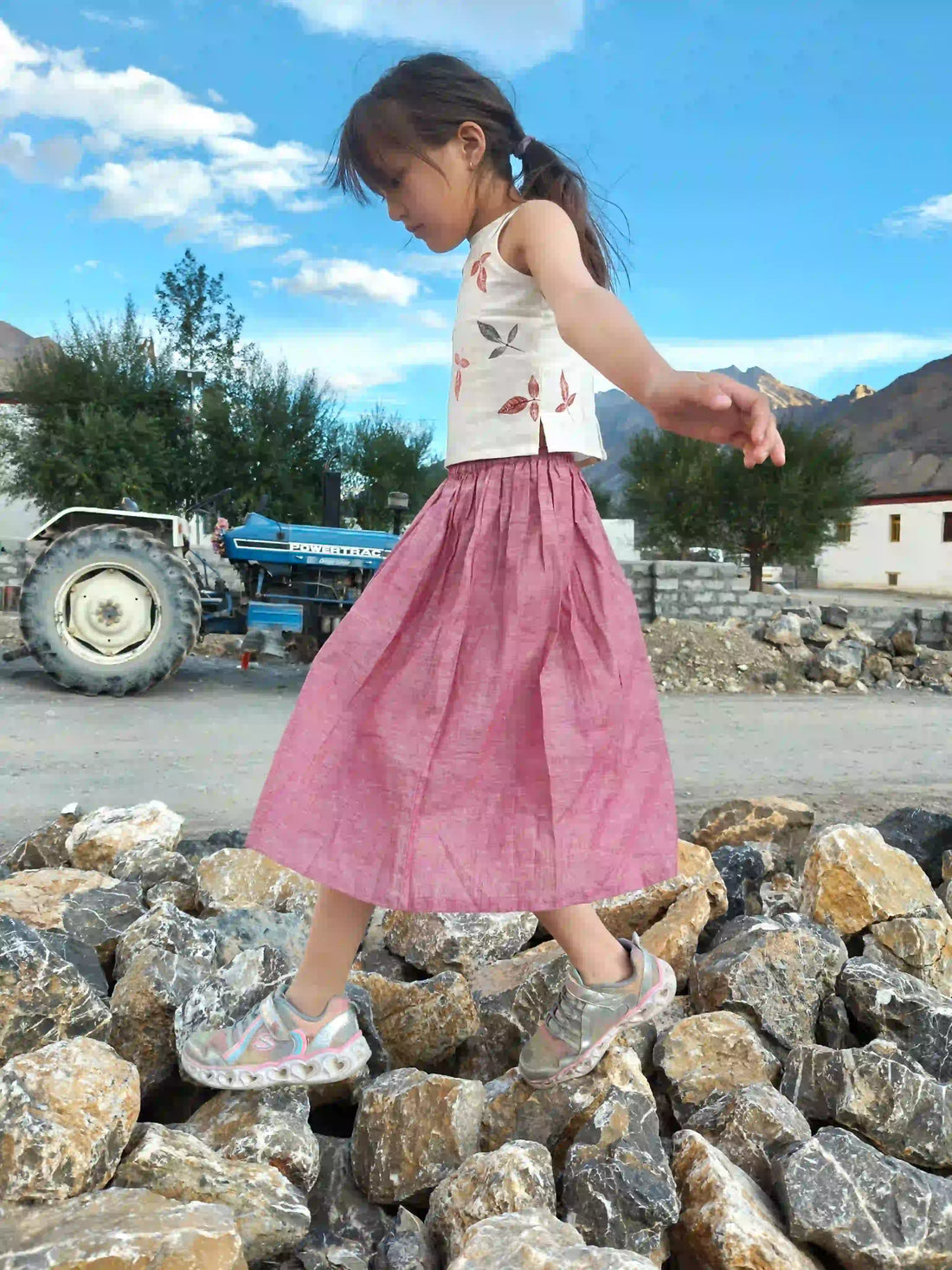 Child wearing minimalist clothing in the mountains