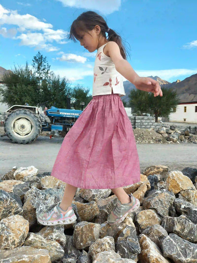 Child wearing minimalist clothing in the mountains