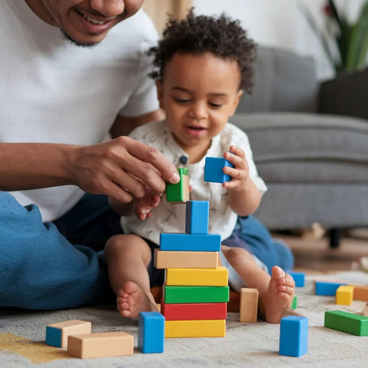Parent and child playing with colorful wooden building blocks on living room floor, educational toy
