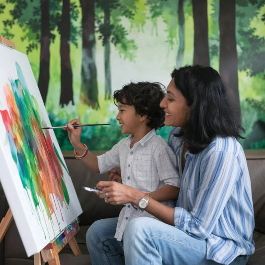 Indian parent and child painting together at home, creative learning with art