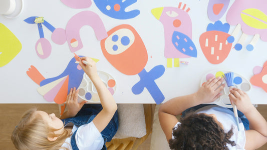 Children making colorful paper bird crafts, engaging in creative DIY activities at a table