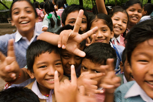 Group of smiling school children in uniforms enjoying outdoor playtime, close up