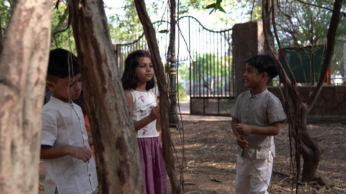 Children wearing cotton clothes playing outdoors among trees, natural setting