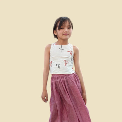 Girl in sleeveless printed khadi top and pink organic cotton skirt, sustainable kidswear