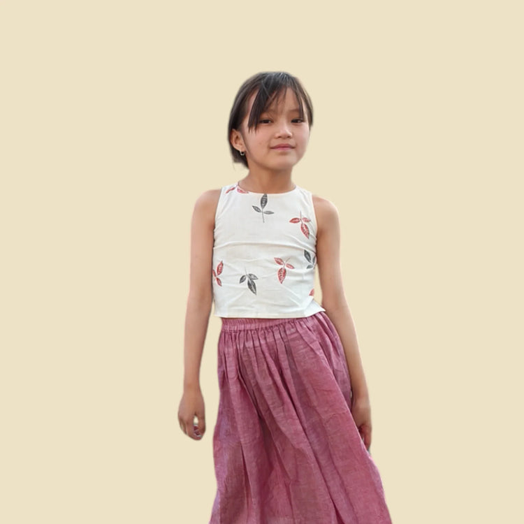 Girl in sleeveless printed khadi top and pink organic cotton skirt, sustainable kidswear