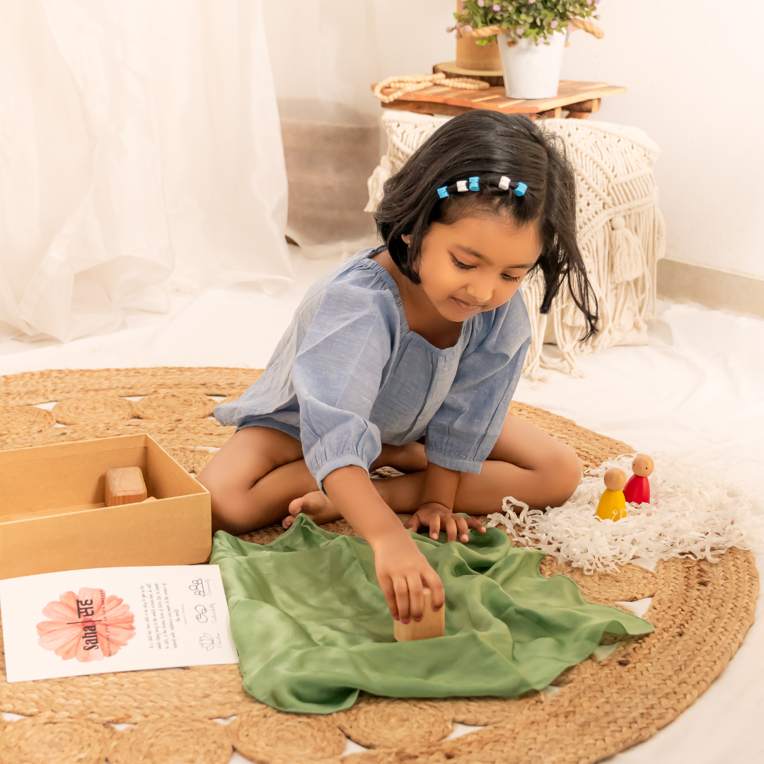 A three year old girl playing with open-ended toys