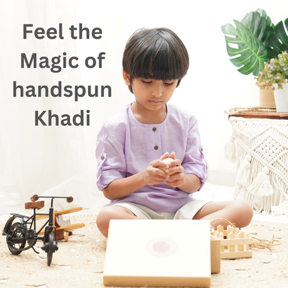 Boy wearing purple cotton shirt and engaged in play with text highlighting Feel the Magic of handspun Khadi