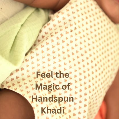Close-up of soft handspun khadi fabric with delicate heart prints used in the breathable Cotton Onesie for babies