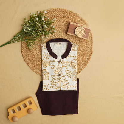Folded khadi short kurta set with handblock-printed Warli motifs and dark Ikat shorts styled with natural props and wooden toys.