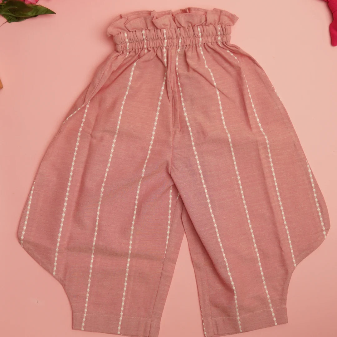 Flat lay of pink handloom cotton pants with soft elastic waist and white striped detailing for comfortable movement
