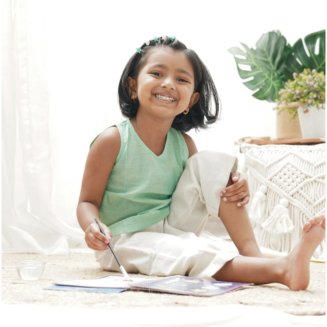 Child playing in green khadi top