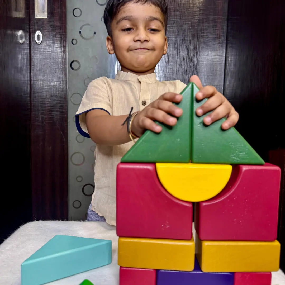 Child playing with colorful wooden building blocks 