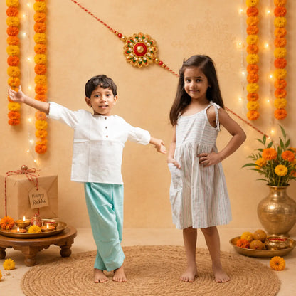 A boy and a girl stand barefoot on a woven rug in a decorated indoor setting for Rakhi festival