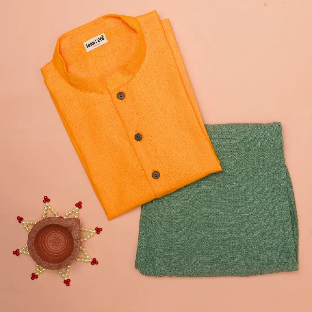 Yellow shirt and green fabric on a peach background with decorative elements.