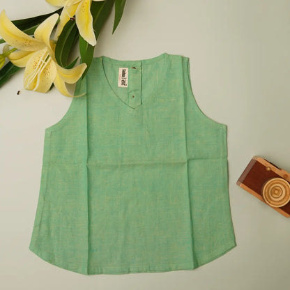 Flat lay of baby girl dress top in cotton khadi – breathable natural toddler outfit