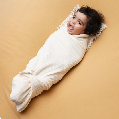 baby wrapped in pure muslin swaddle