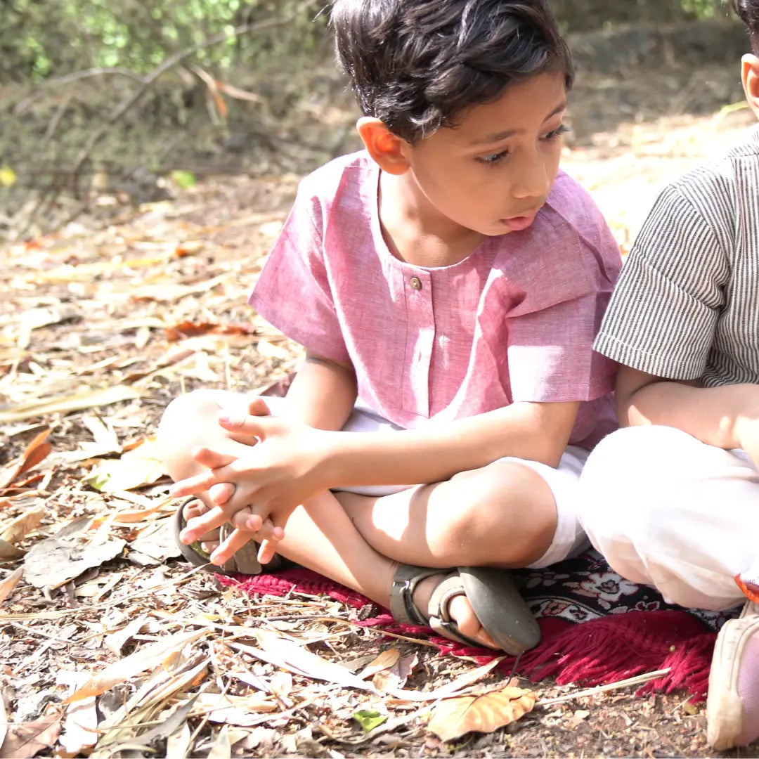 Boy wearing Earthy Elegance kurta shirt and shorts set in nature - perfect for play