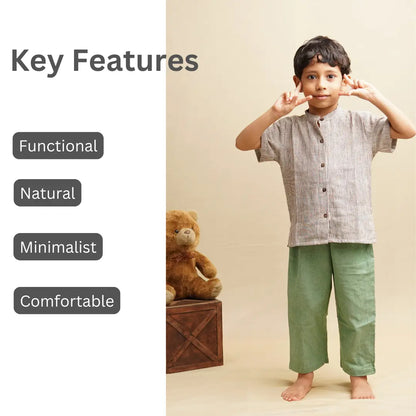Child wearing a striped shirt and green pants with key features of handwoven clothing