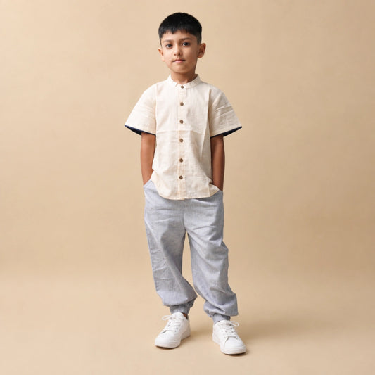 Boy wearing a comfortable jogger and shirt set in breathable natural fabric