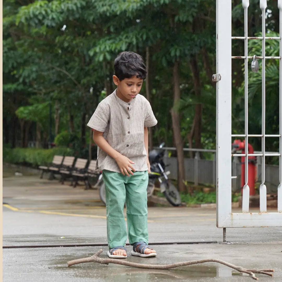 Boy wearing a khadi shirt and trousers while playing outdoors