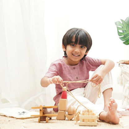 Child wearing cotton joggers playing with wooden toys