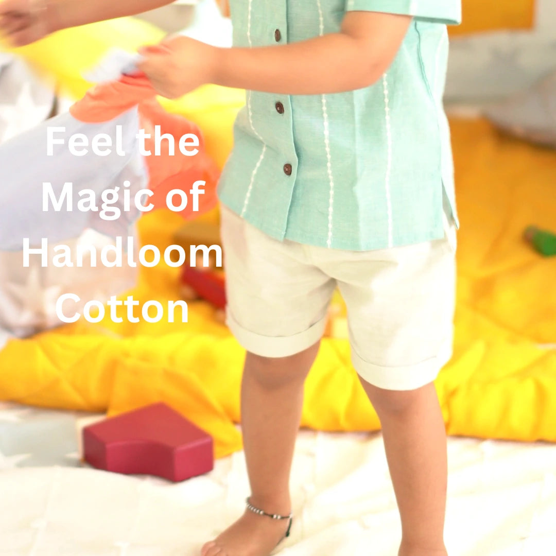 Close-up of breathable handloom cotton shirt for kids with wooden buttons and soft beige shorts styled for minimal everyday wear