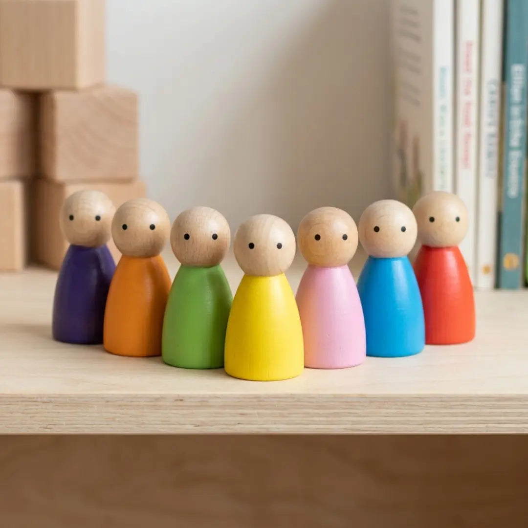 Colorful Wooden Peg Dolls handcrafted from beechwood in seven vibrant colours for open-ended play, storytelling, and Waldorf-inspired learning.