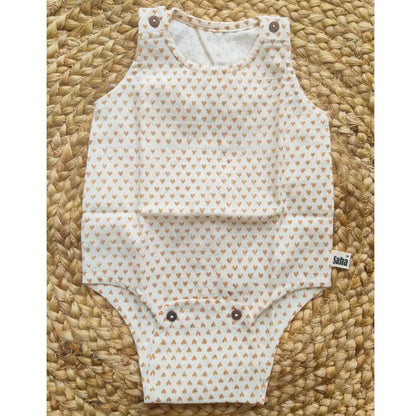 Flat lay of the unisex baby Romper in handspun khadi fabric with tiny heart prints and snap buttons for easy diaper changes