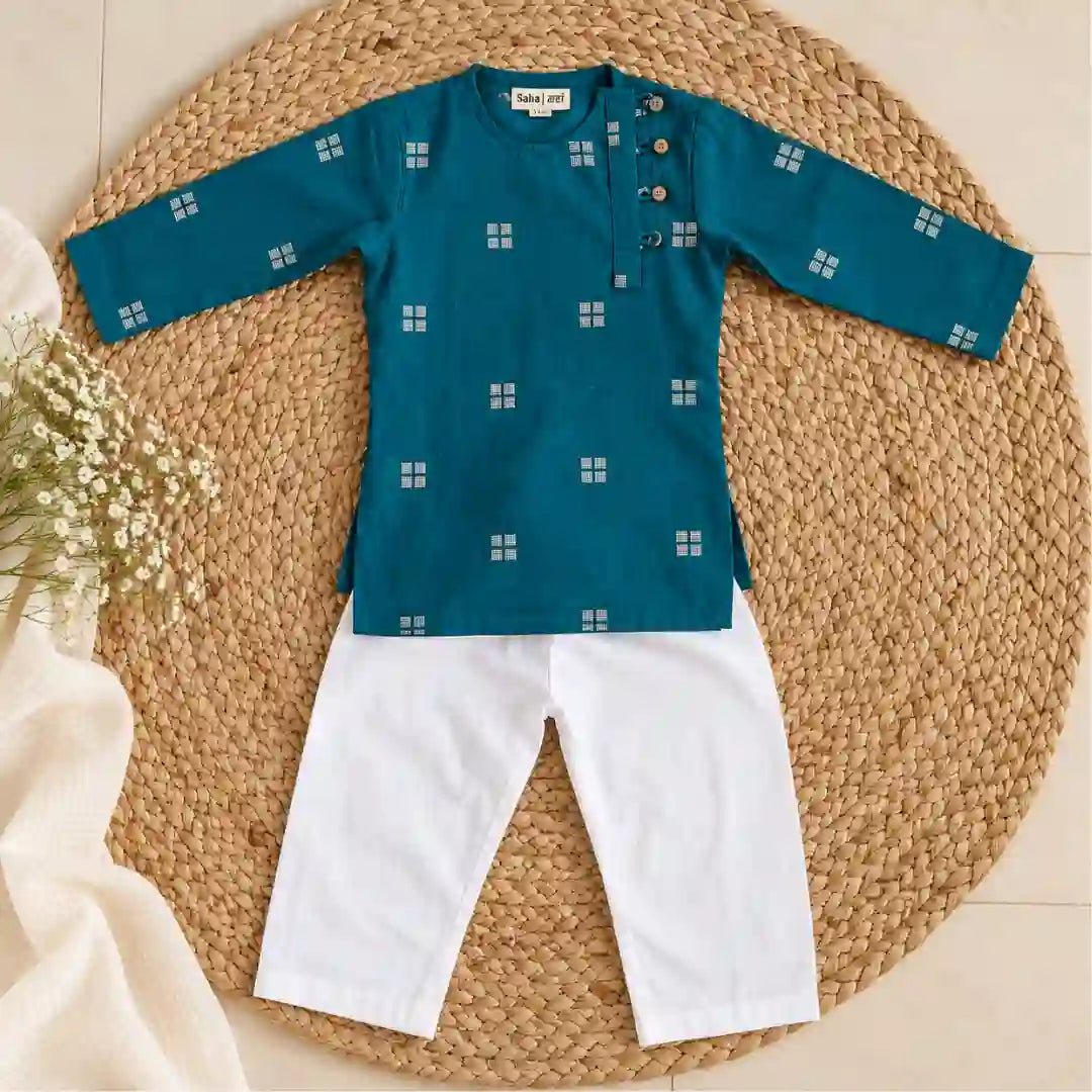 Flat lay of a teal full sleeve kurta with white square motifs and buttons beside a white pajama
