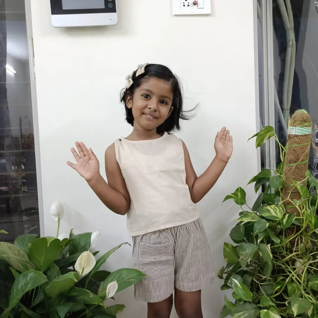 Young girl wearing cotton top and shorts 
