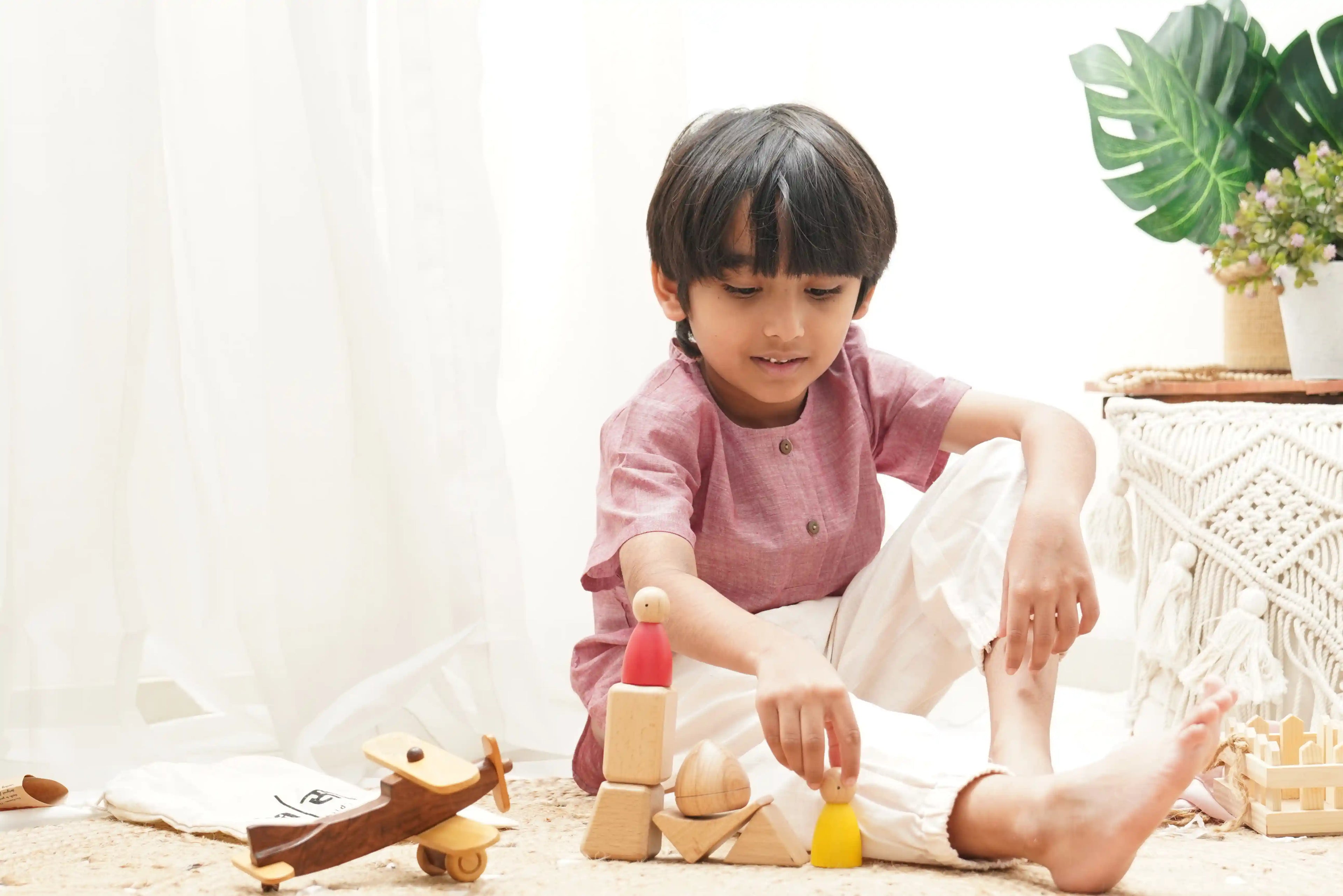 Preschooler dressed in handwoven cotton clothing engaged in play