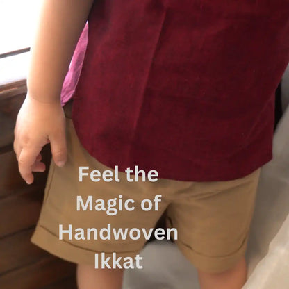 Close-up of the handwoven ikkat shirt fabric and cuffed beige shorts