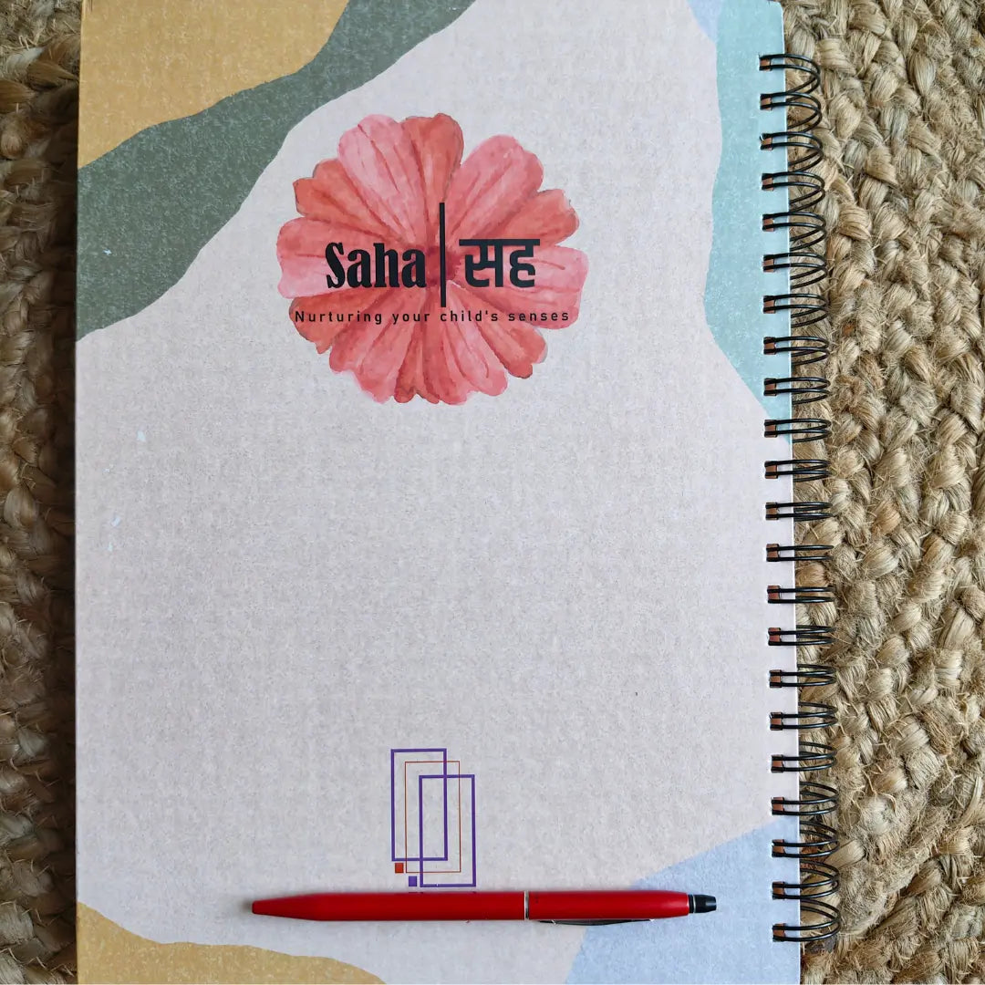 Journal for mothers with a red pen on a textured surface