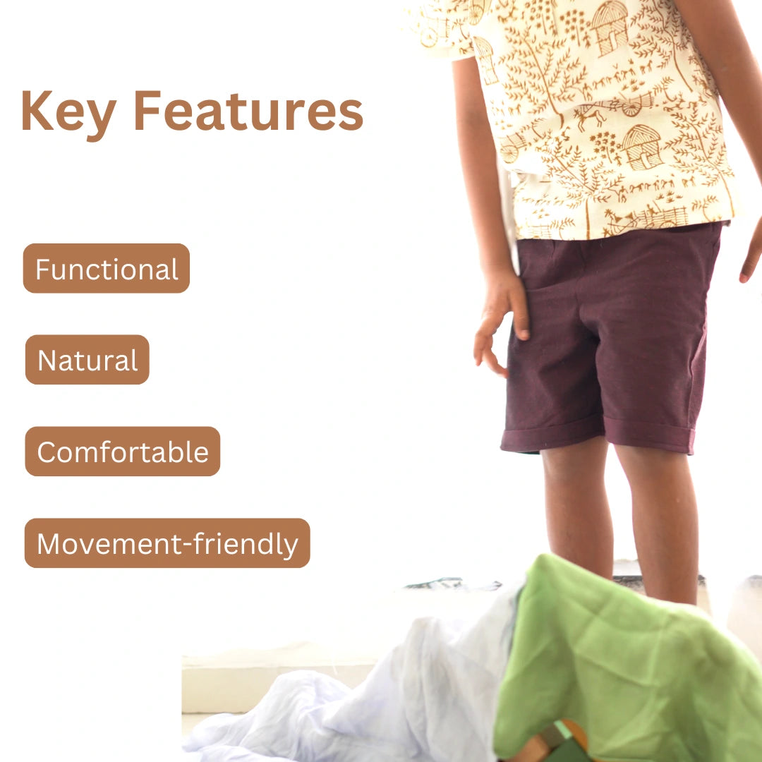 Child wearing breathable khadi short kurta set with Warli handblock print and dark Ikat shorts, highlighting functional, natural, comfortable, and movement-friendly features.