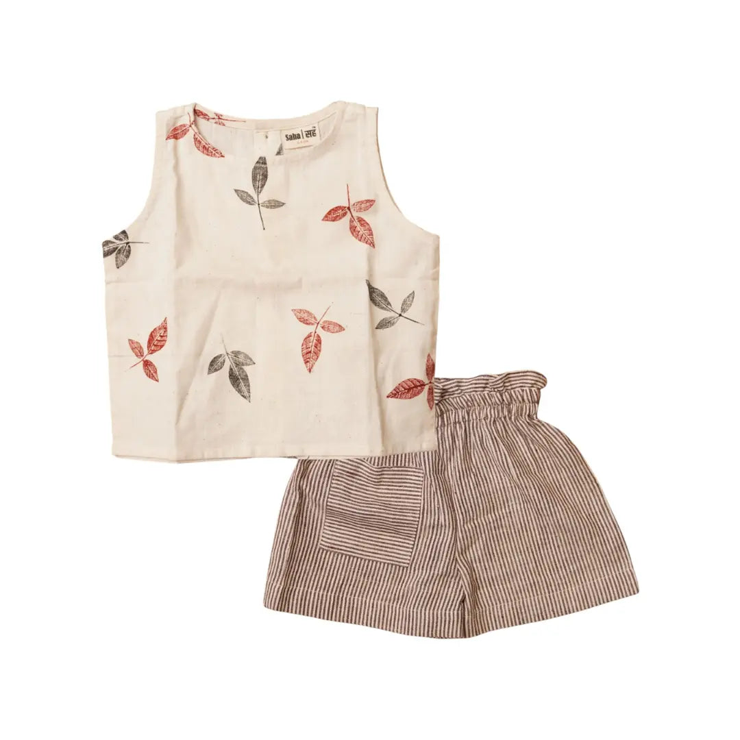 Beige sleeveless top with leaf patterns and striped shorts on a white background