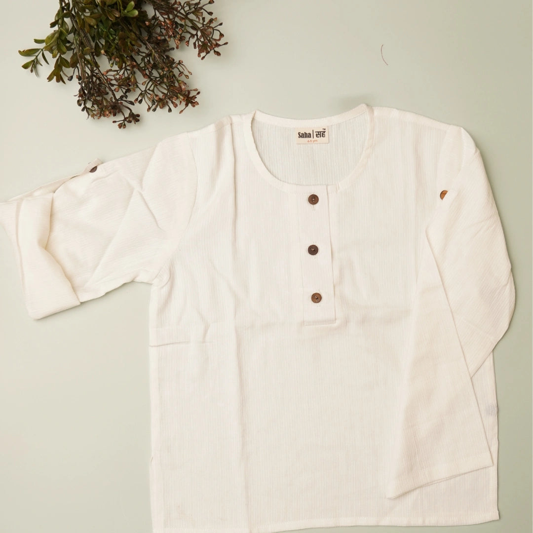 Flat lay of white khadi shirt – breathable natural outfit for kids