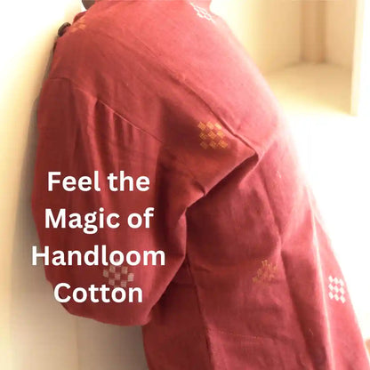 Close-up of a maroon handloom cotton kurta sleeve with gold and white woven diamond motifs