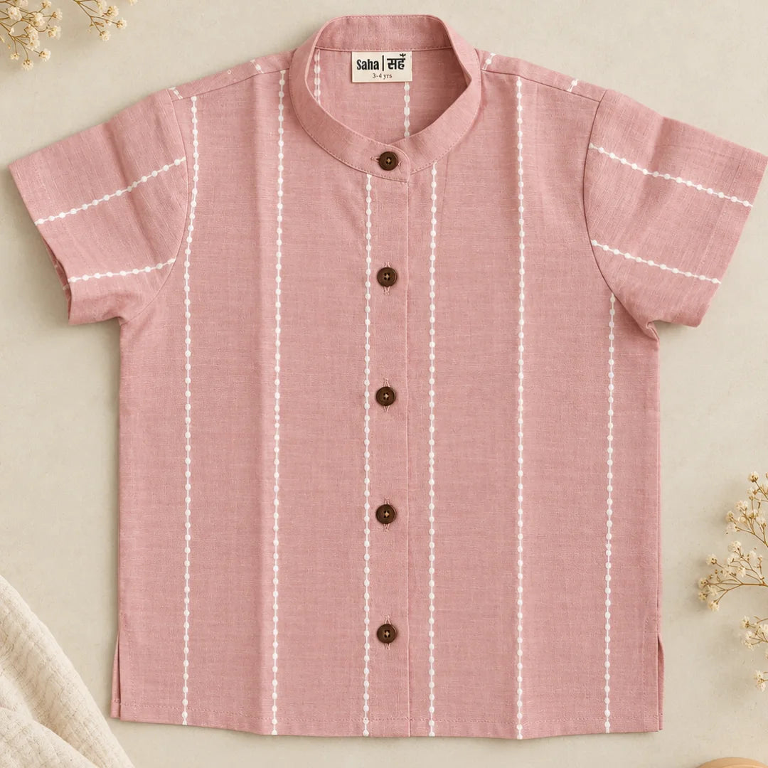 Flat lay of a mauve unisex cotton shirt for kids with mandarin collar, wooden buttons and white woven raindrop stripes
