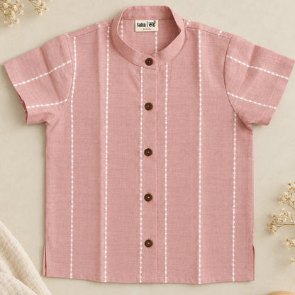 Flat lay of a mauve unisex cotton shirt for kids with mandarin collar, wooden buttons and white woven raindrop stripes