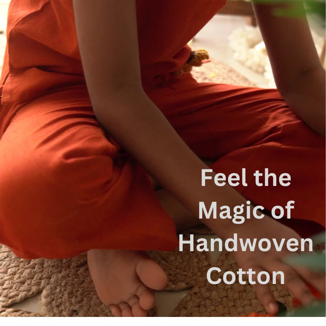 Close-up of rust orange handwoven ikat cotton pants as a child sits cross-legged