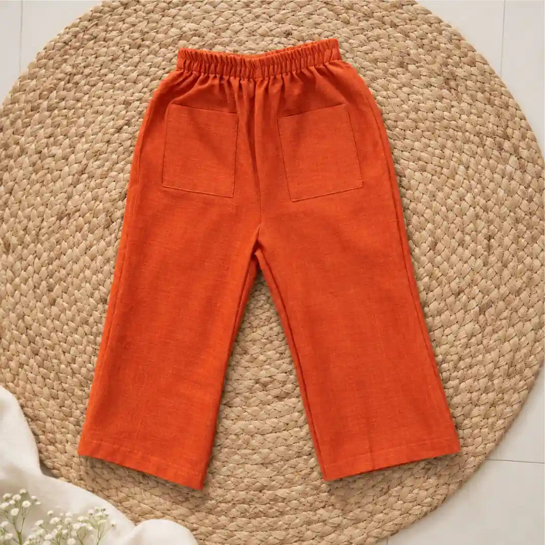 Rust orange handwoven ikat wide-leg pants with an elasticated waist and two patch pockets
