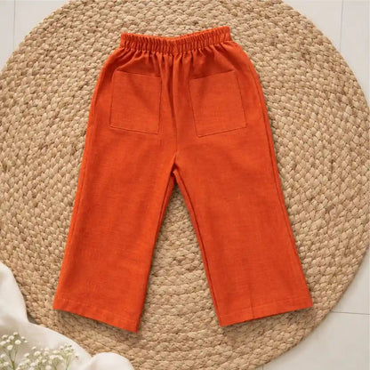 Rust orange handwoven ikat wide-leg pants with an elasticated waist and two patch pockets